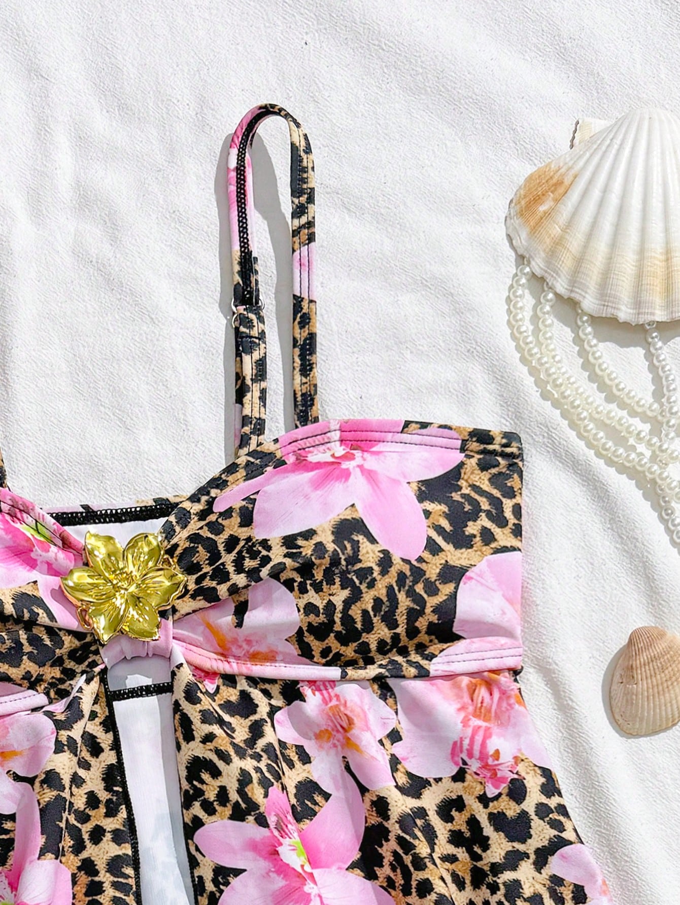 Tween girls two-piece tankini swimwear set with spaghetti straps, asymmetrical design, and 3D rose detail. Features a plant-pattern top and mid-waist bottoms in stretchy fabric for beach or pool wear.