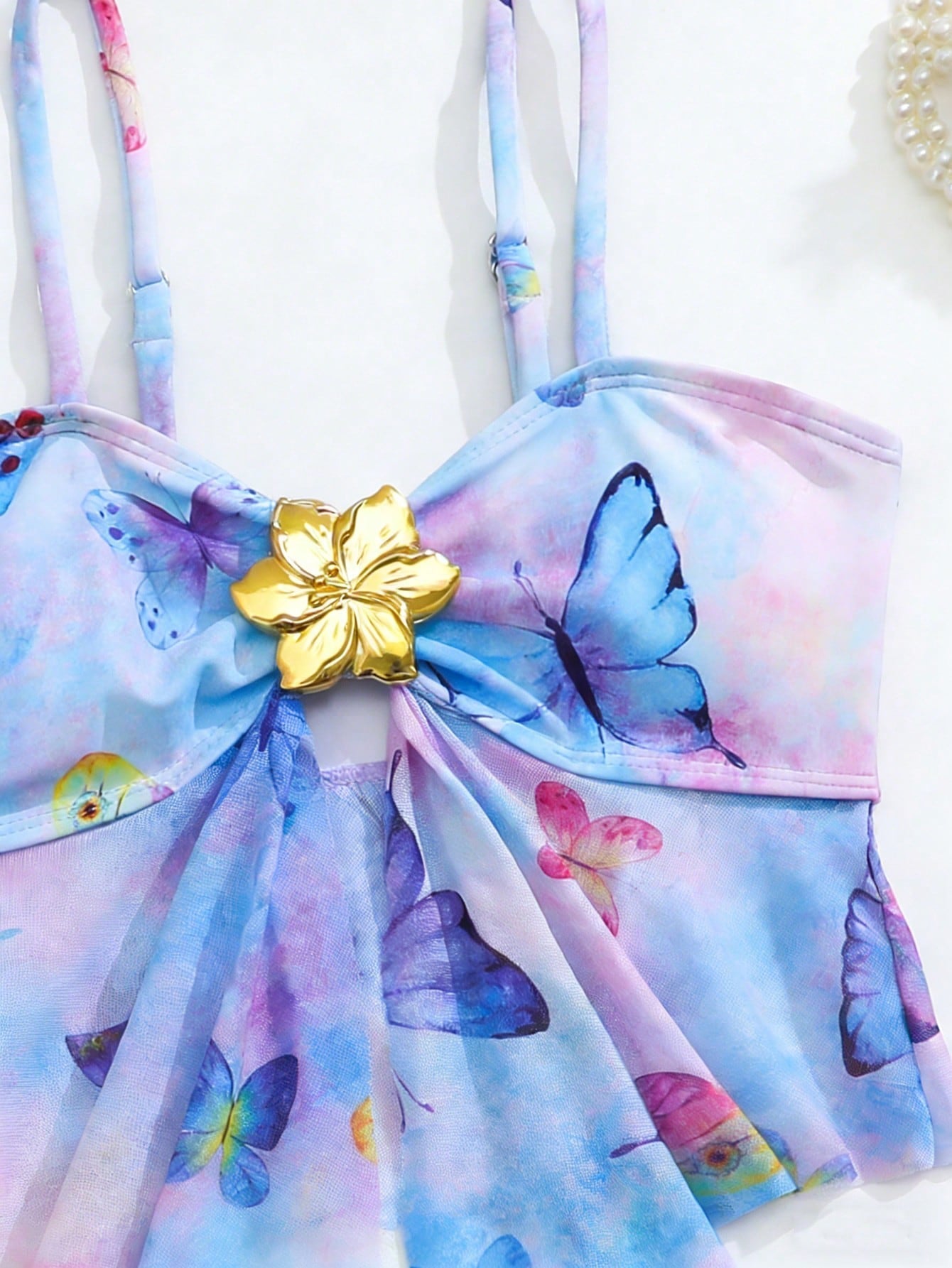 Tween girls two-piece tankini swimwear set with spaghetti straps, asymmetrical design, and 3D rose detail. Features a plant-pattern top and mid-waist bottoms in stretchy fabric for beach or pool wear.
