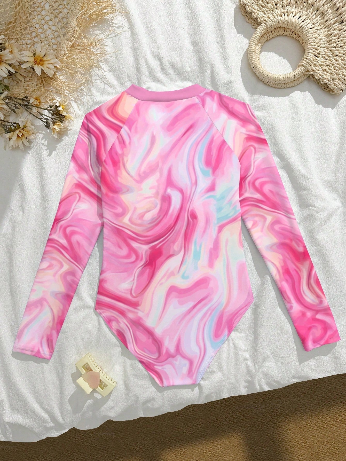 Tween girls one-piece rash guard swimsuit with long sleeves, high neck, front zipper, and ocean shell graphic print in a fitted style for beach, swimming, and vacation wear.