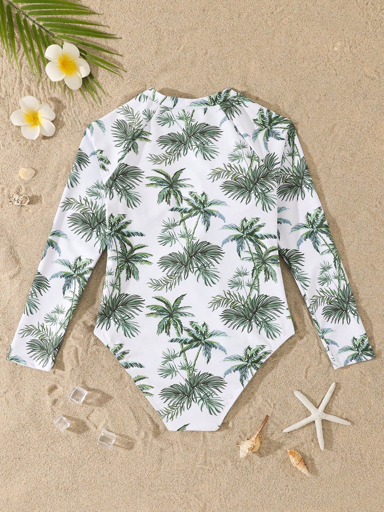 Tween girls one-piece rash guard swimsuit with long sleeves, high neck, front zipper, and ocean shell graphic print in a fitted style for beach, swimming, and vacation wear.