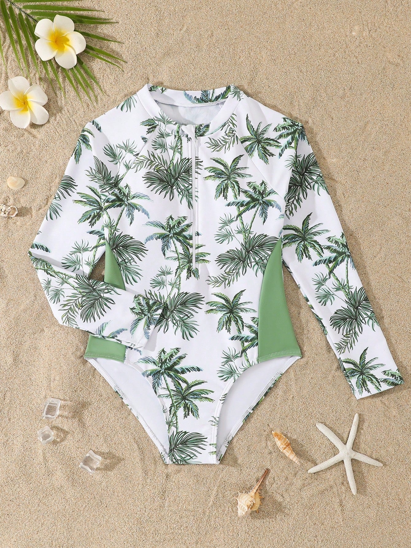 Tween girls one-piece rash guard swimsuit with long sleeves, high neck, front zipper, and ocean shell graphic print in a fitted style for beach, swimming, and vacation wear.