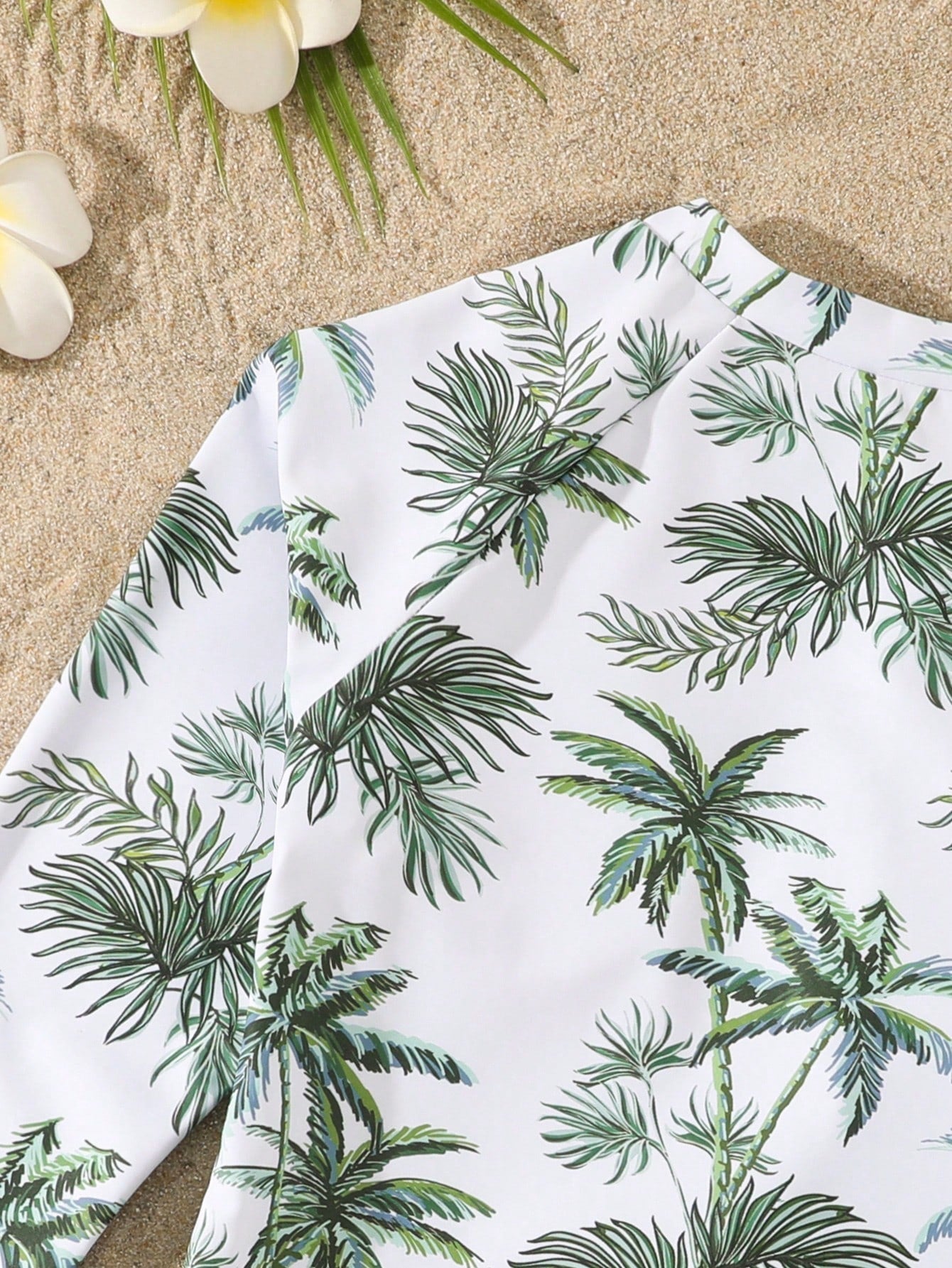 Tween girls one-piece rash guard swimsuit with long sleeves, high neck, front zipper, and ocean shell graphic print in a fitted style for beach, swimming, and vacation wear.